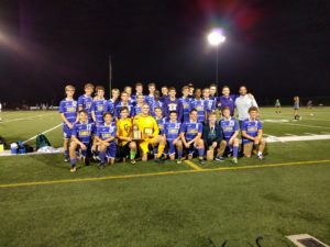 Boys soccer celebrates with their district trophy.